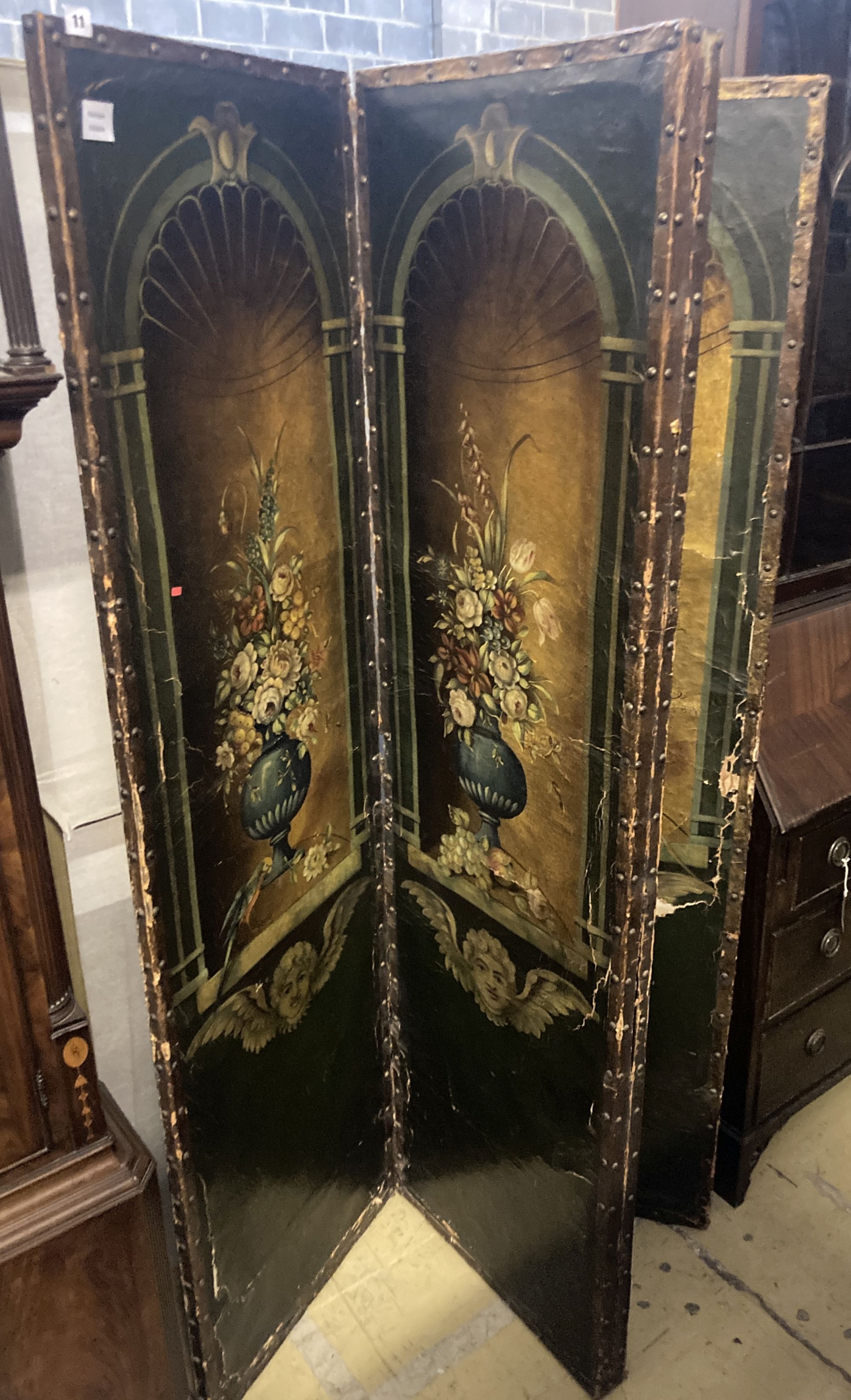 A 19th century Spanish leather four leaf draught screen, painted with vases of flowers, each panel width 53cm height 184cm